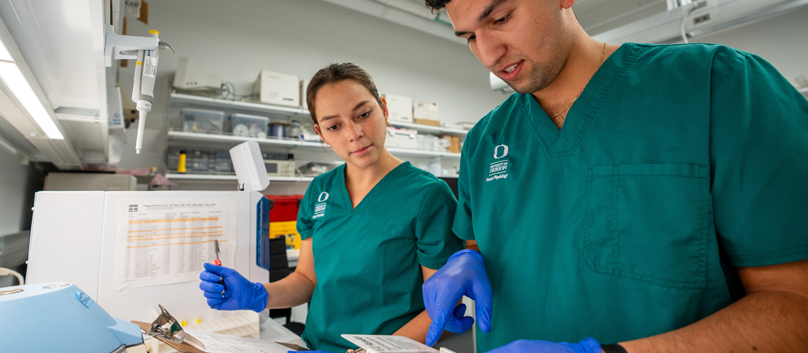 Man and woman in lab looking at data.